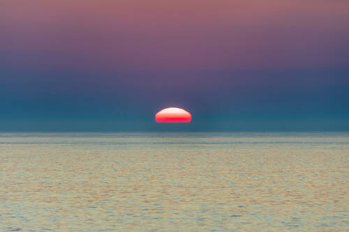 Sunset over the Delaware Bay in Pastel hues with glowing water (decorative)